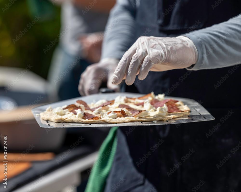 Pizza Chef putting fresh made pizza in pizza oven. Pizza Chef putting fresh made pizza in pizza oven.