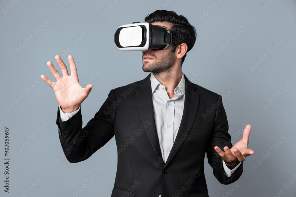 Professional business man holding something while using VR glasses to enter metaverse. Project manager looking at data analysis while wearing suit and virtual reality goggles. Innovation. Deviation.