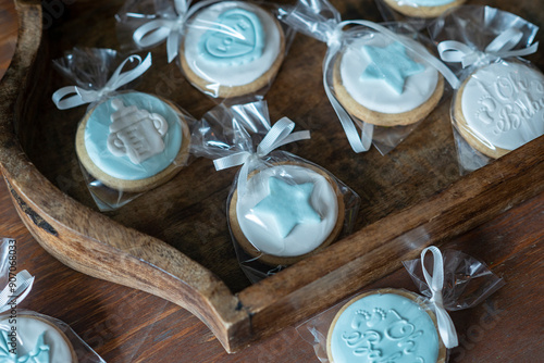 Billede på lærred Top view image of  cookies wrapped with blue ribbon in cellophane  and decorated