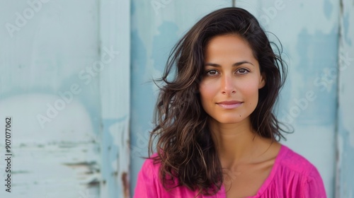 Smiling Woman in Pink Top Against a Soft Pink Background