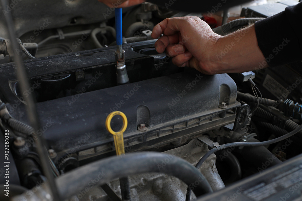 Auto mechanic installs ignition in car, auto repair Auto mechanic installs ignition in car, auto repair