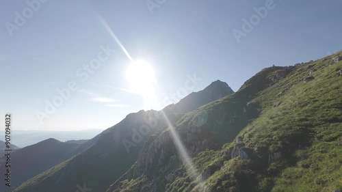 FPV drone flight above mountain ridge and peak. Close to the ground flight through Gantrisch mountains in alps in Switzerland.