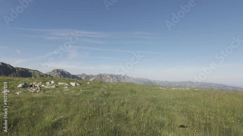 FPV drone flight above mountain ridge and peak. Close to the ground flight through Gantrisch mountains in alps in Switzerland.