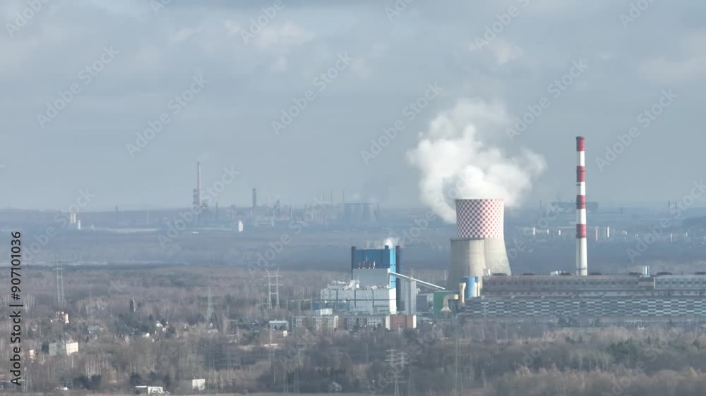 Aerial drone view of the chimneys of a coal fired power plant.Large chimneys of the power plant cooling tower. Drone flight past the power plant. Industrial Power plant in Bedzin, Poland. Aerial drone view of the chimneys of a coal fired power plant.Large chimneys of the power plant cooling tower. Drone flight past the power plant. Industrial Power plant in Bedzin, Poland.