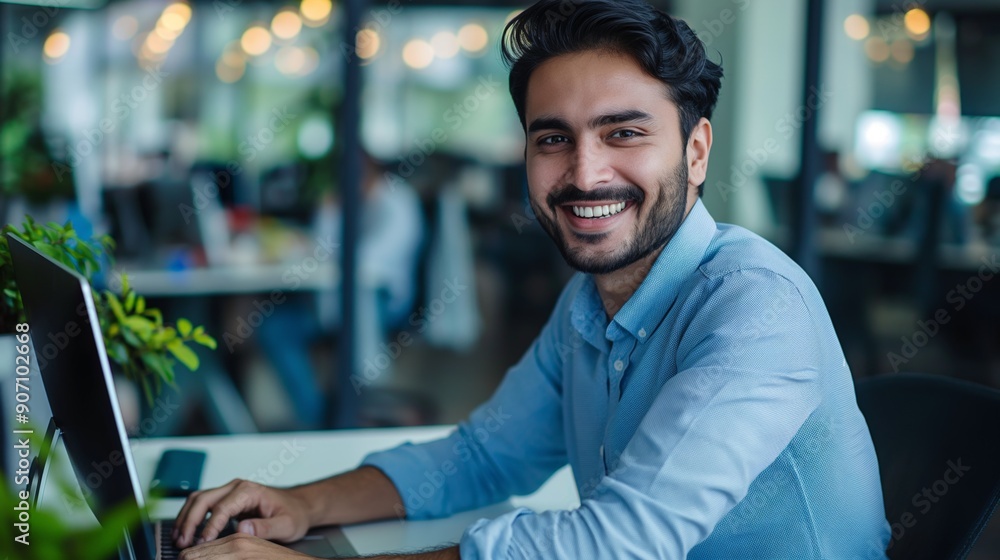 Portrait of a smiling businessman working on a laptop Portrait of a smiling businessman working on a laptop