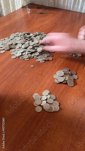 Coins spilling out of a clay jug piggy bank