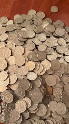 Coins spilling out of a clay jug piggy bank