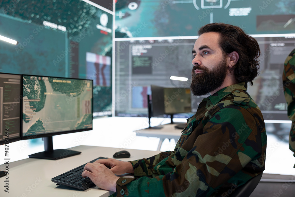 Φωτογραφία High tech specialist reviewing satellite CCTV footage on a big screen, preparing soldiers for a new national safety mission
