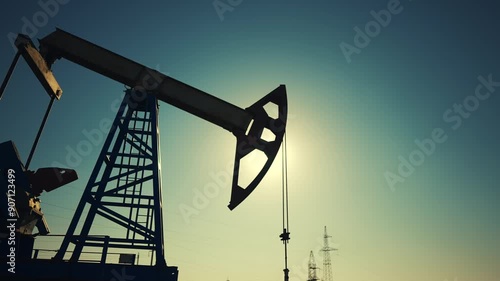 oil industry. silhouette of an oil pump lifestyle extracts oil and gas from ground of the field. business industry concept. pump pumps oil and gas at sunset. drill petroleum middle sunlight industry photo