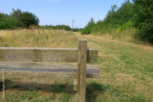 A wooden bench overlooking the North Kent countryside on a hot summers day