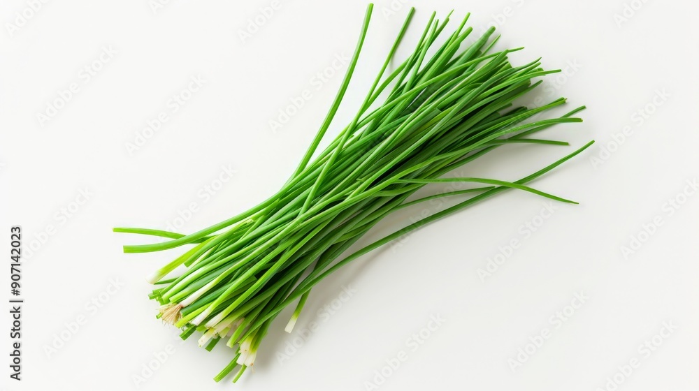 A close-up shot of freshly harvested green chives, laying on a white surface, capturing their freshness and vibrant green color suitable for culinary uses. A close-up shot of freshly harvested green chives, laying on a white surface, capturing their freshness and vibrant green color suitable for culinary uses.