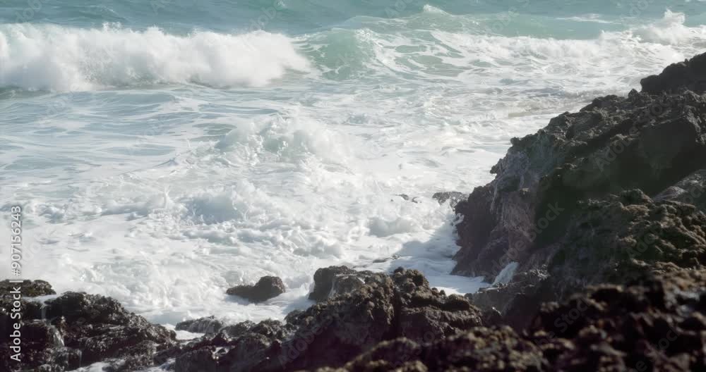 waves crash against the volcanic rock waves crash against the volcanic rock