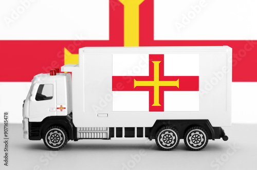 Guernsey flag depicted on side wall of white delivery van close up. Shipping and local delivery concept photo