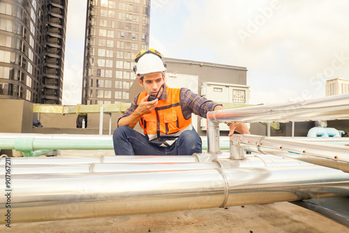 Male HAVC refrigeration system technician work inspect stainless steel insulation delivery and suction pipes refrigeration systems check for damage equipment and inspect prevent leaks ensure safety. photo