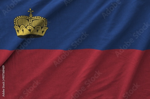 Liechtenstein flag depicted on folded wavy fabric of old cloth close up photo