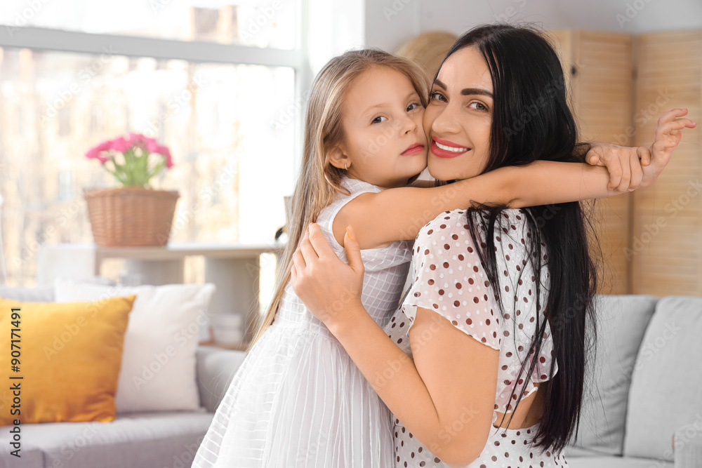 Happy mother with her little daughter hugging at home Happy mother with her little daughter hugging at home