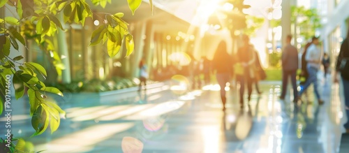 Blurred image of busy people walking in modern office lobby during rush hour. Concept of business, work, commute, city life.