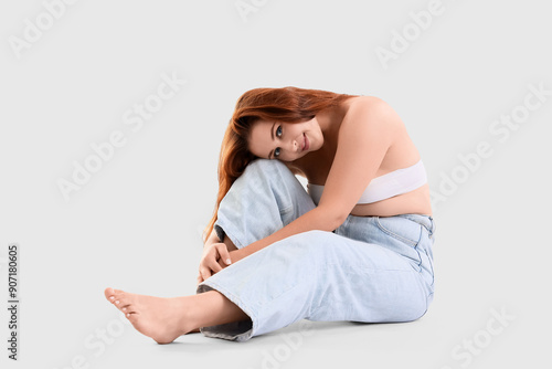 Young plus size woman sitti...