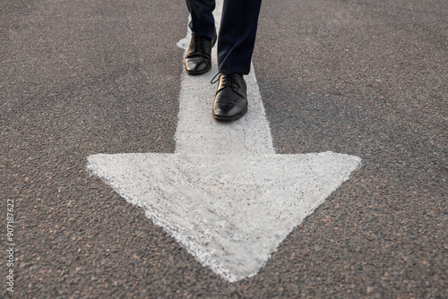 Businessman walking along r...