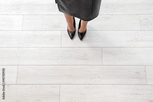 Woman standing on wooden fl...