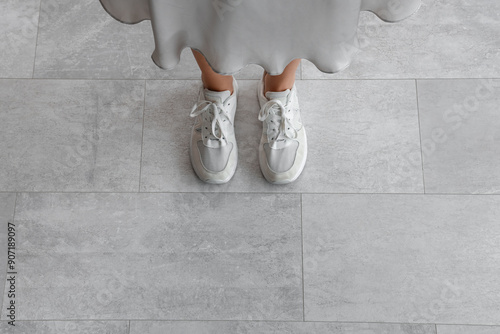 Woman standing on tiled flo...