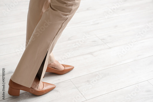 Woman walking on wooden flo...