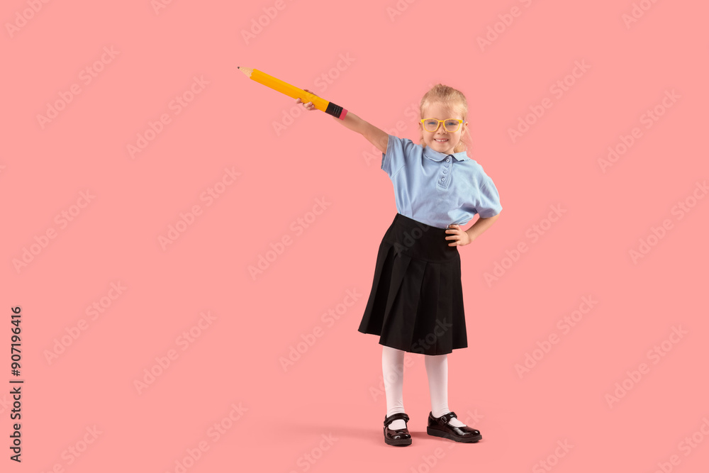 Cute little schoolgirl with big pencil on pink background Cute little schoolgirl with big pencil on pink background