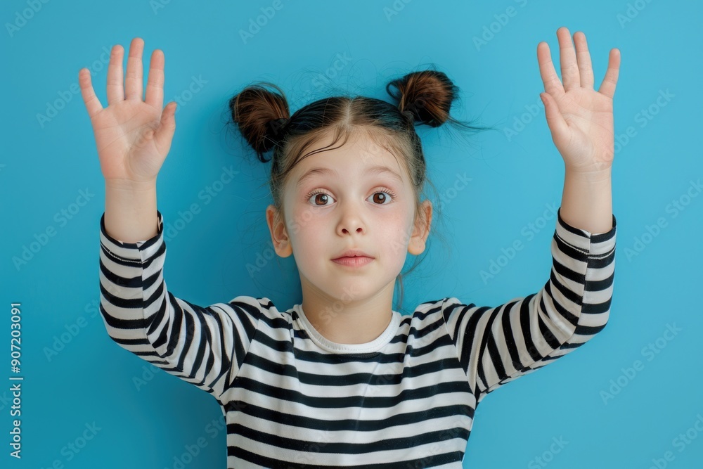 A young child celebrating or expressing herself with arms raised A young child celebrating or expressing herself with arms raised