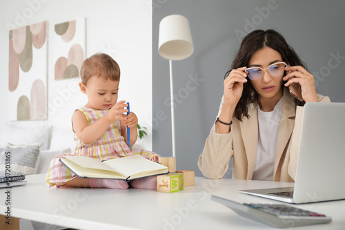 Working mother with her lit...