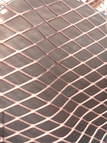 The texture of the white metal mesh is close up. He goes into the distance and loses focus