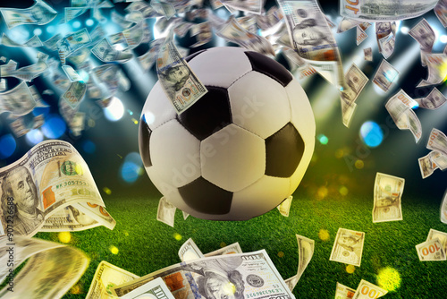 Money and soccer ball in air at stadium photo