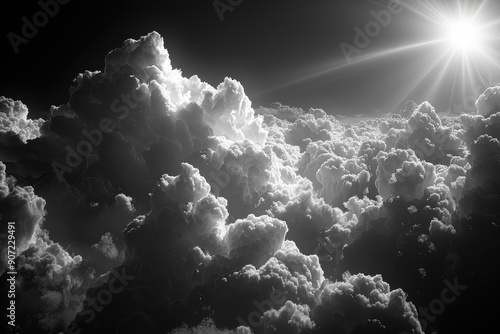 A Dramatic Black and White View of Fluffy Clouds with a Sunburst photo