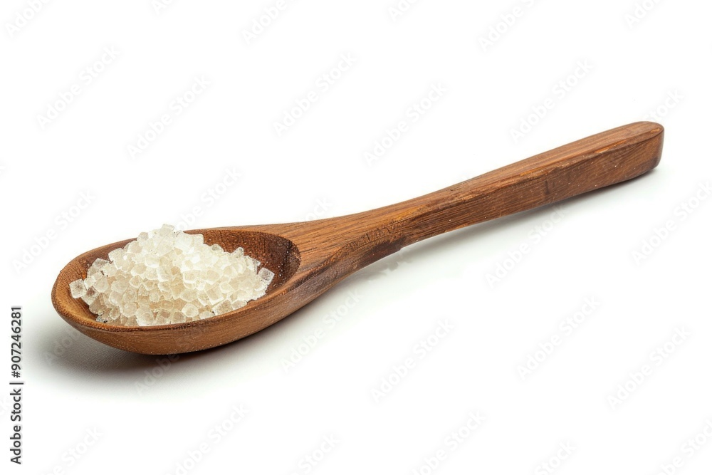 A wooden spoon filled with sea salt on a white surface, perfect for seasoning or decorative use