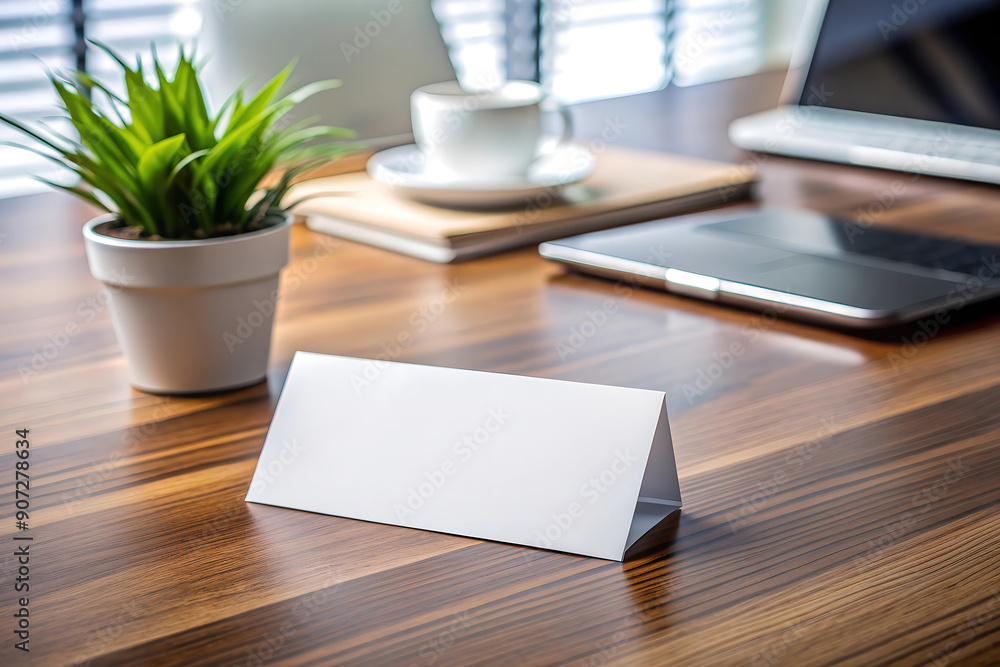 Blank white paper table tent on wooden office desk Blank white paper table tent on wooden office desk