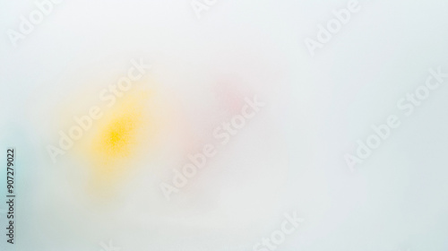 Behind the glass, the subtle suggestion of a bouquet is softly discernible - a blurred pink, blue and yellow shape with no definable details photo