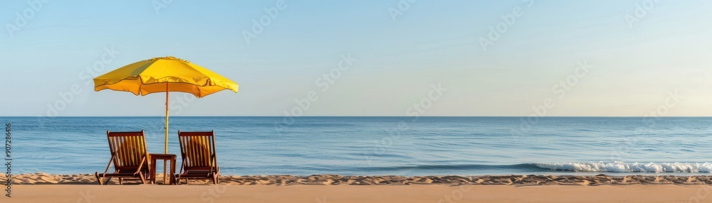 A tranquil beach scene featuring a yellow umbrella and chairs by the calm sea, perfect for relaxation and summer vibes. A tranquil beach scene featuring a yellow umbrella and chairs by the calm sea, perfect for relaxation and summer vibes.