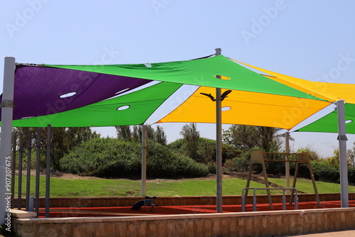 A canopy for protection from the hot sun in a city park.