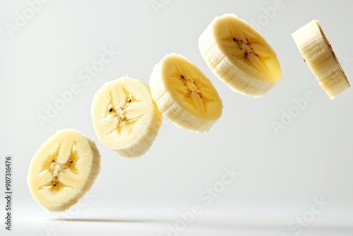 Falling peeled round banana slices isolated on white background. Place for text photo