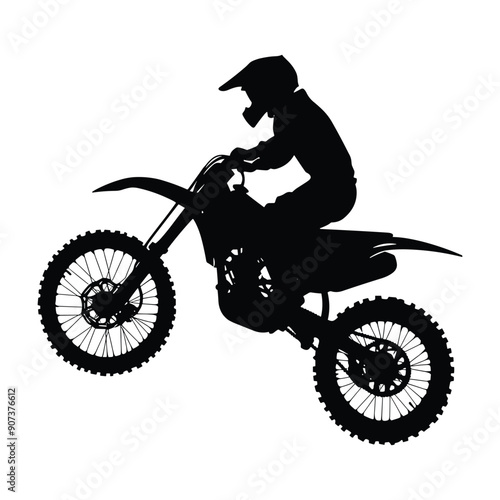Silhouette of a motocross rider performing a stunt on a dirt bike.