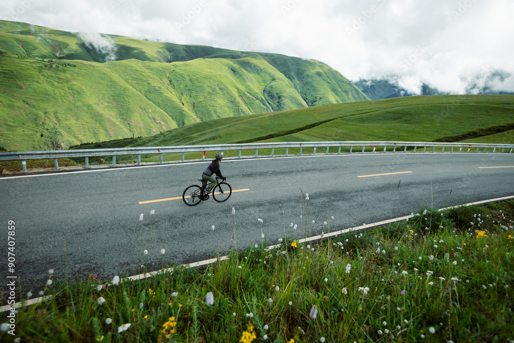 Obraz premium Riding bike on grassland mountain top trail