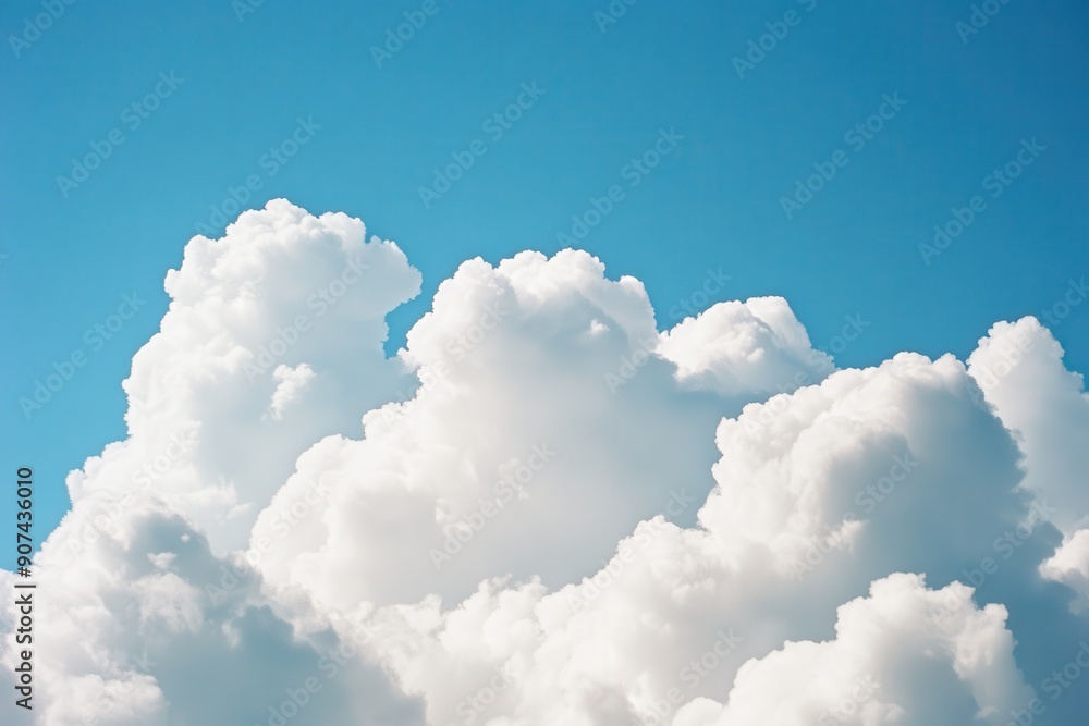 Fluffy white clouds in a clear blue sky Fluffy white clouds in a clear blue sky