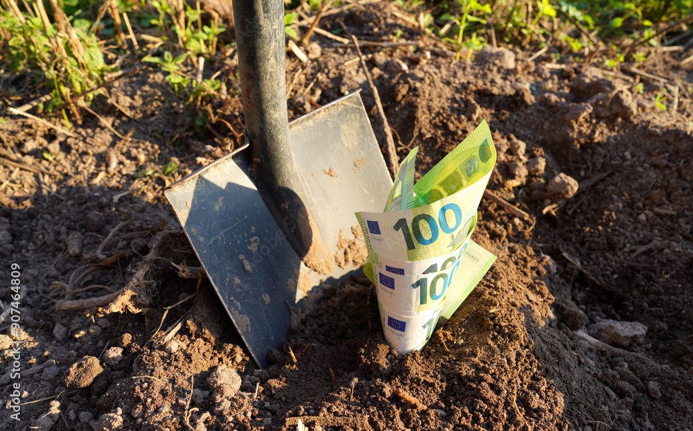Shovel with Euro money on ground. Bury money. Digging money in soil. Digs EURO coins note from ground. EURO bills in European Union Crisis. Euro bills growing out of soil. Burying money in backyard. Shovel with Euro money on ground. Bury money. Digging money in soil. Digs EURO coins note from ground. EURO bills in European Union Crisis. Euro bills growing out of soil. Burying money in backyard.