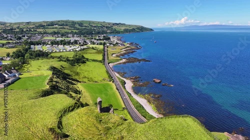 Aerial View of Red Bay Castle Cushendall Waterfoot on the Irish Sea Co Antrim Northern Ireland on a sunny day with a blue sky  photo