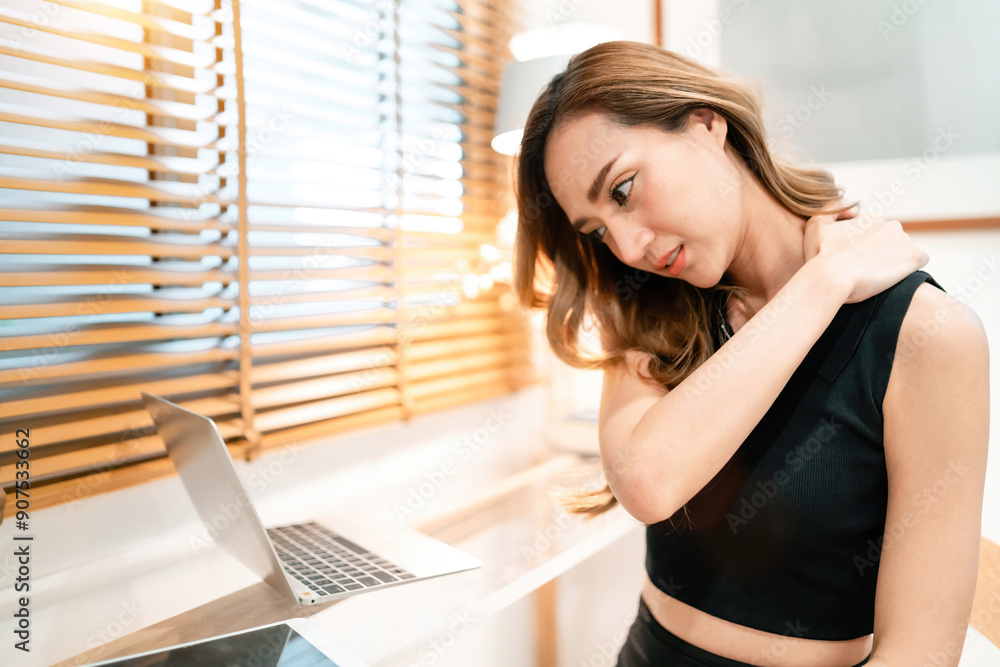 fatigued beautiful woman rubbing neck working using laptop. gorgeous ...