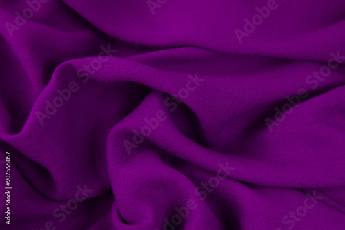 Purple fabric background. Purple cloth waves background texture. Purple fabric cloth textile material.