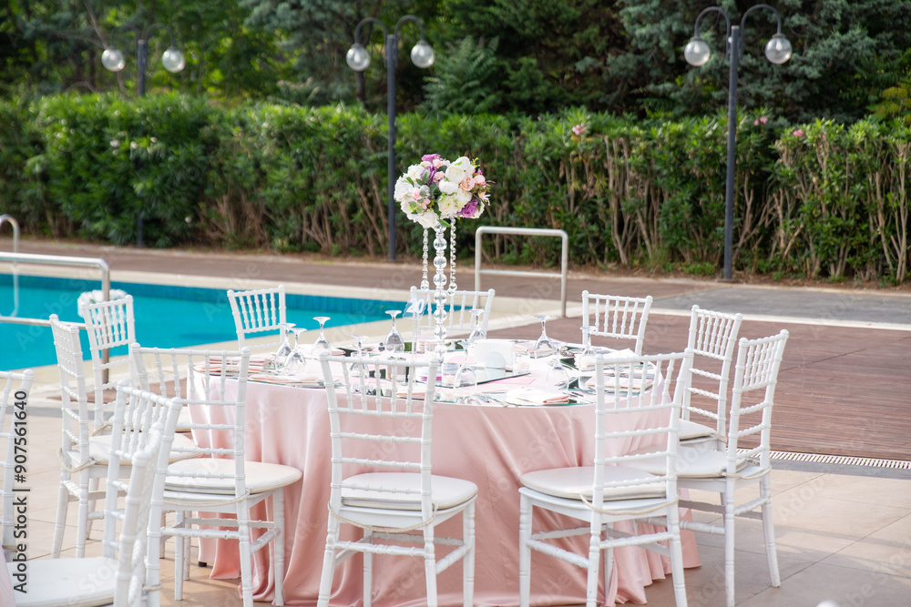 Beautifully Decorated Wedding Tables by the Swimming Pool Outdoors