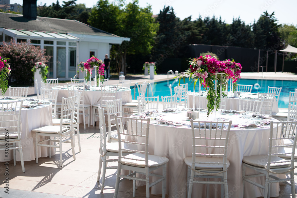 Beautifully Decorated Wedding Tables by the Swimming Pool Outdoors