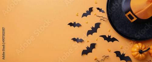 Creative Halloween Decor Featuring Black Bats and a Yellow Witch Hat on Orang...