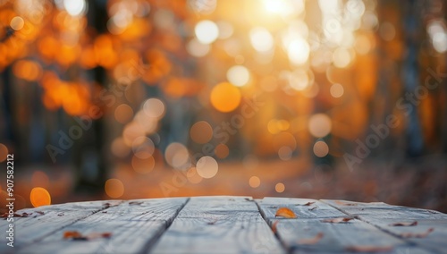 Autumn Leaves on Wooden Deck Surrounded by Blurry Orange Forest in Sunset Light