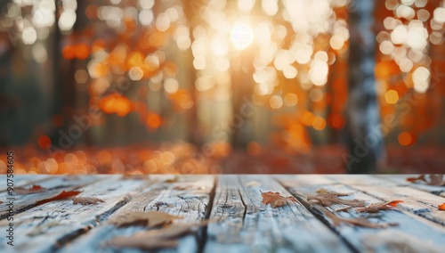 Autumn Leaves on Wooden Deck Surrounded by Blurry Orange Forest in Sunset Light